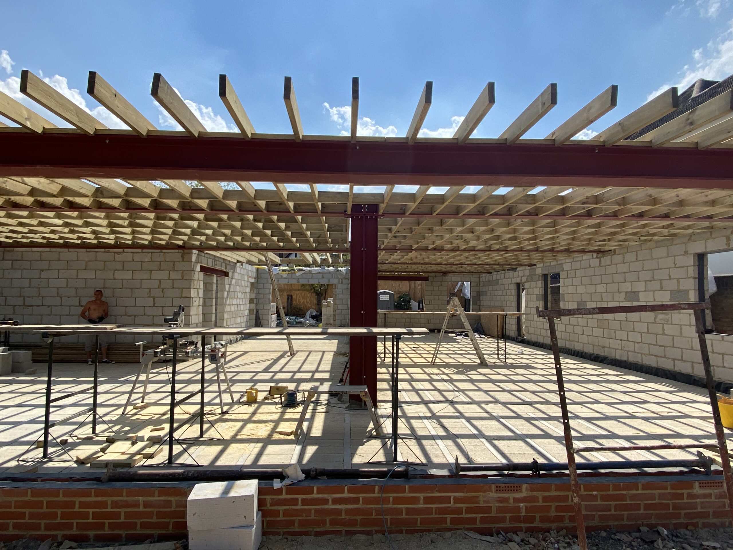Workers installing a custom steel mezzanine floor in a commercial space.